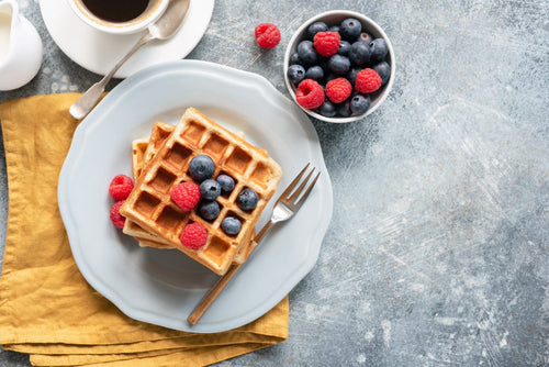 A stack of waffles topped with berries