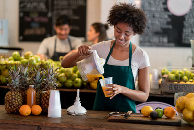 Woman pouring juice into a glass 